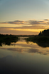 Obraz premium Beautiful calm golden landscape at the sunset of the lake
