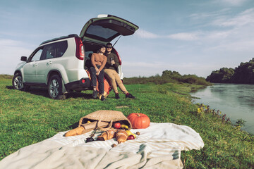 couple having picnic date at river beach