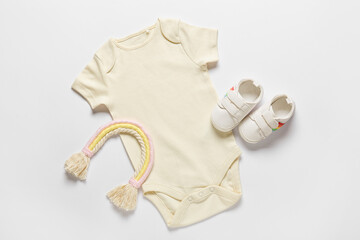 Baby clothes, toy and shoes on white background