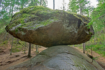 A large balancing boulder rock called Kummakivi in Finnish nature near Ruokolahti - 449193819