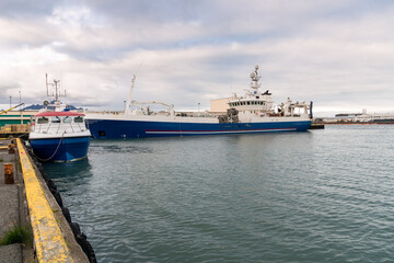 Fish factory ship moored in a harbour in Iceland on a cloudy summer day