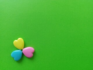 Three love objecs on green background
