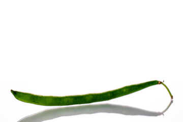 One organic ripe pod of green beans, close-up, isolated on white.