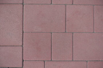 Background - pavement made of simple pink concrete blocks
