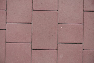 Fototapeta premium Close view of pavement made of pink concrete blacks