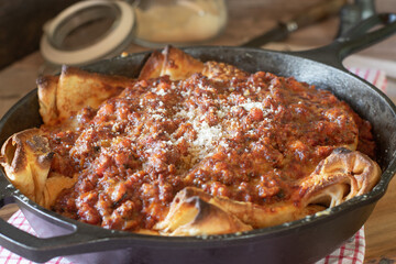 Italian cuisine.  filled pancakes with mozzarella cheese, topped with bolognese sauce and parmesan cheese