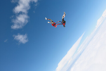 Fototapeta na wymiar Skydiving. A freefly jump is in the blue sky.