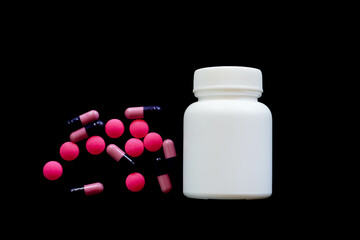 medical pills on black background, bottle of pills concept virus fever