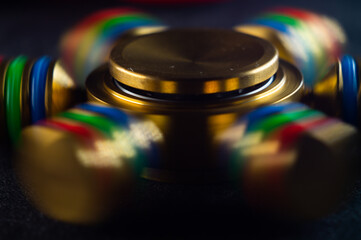 Closeup shot of a metallic colorful spinner rotating.
