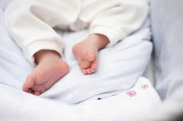 Small baby feet in mother hands