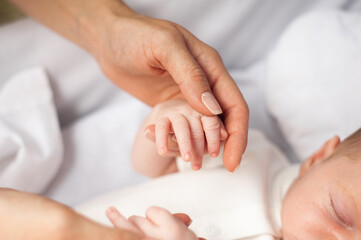 Concept of love and family. hands of mother and baby closeup