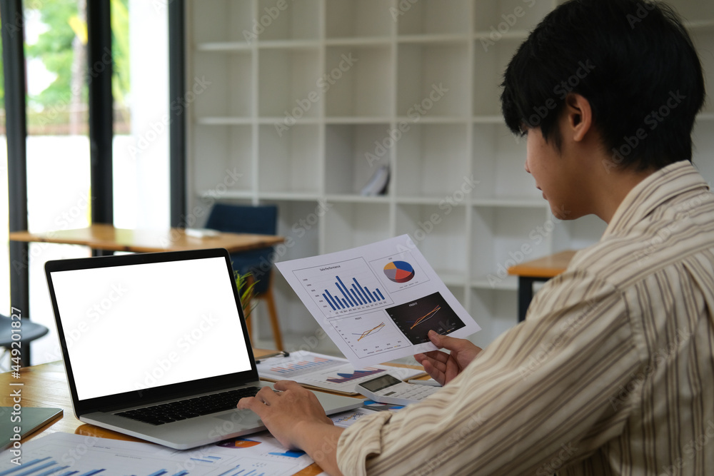 Poster closed up with asian businessman analysis with data paper and use laptop computer, empty screen of l