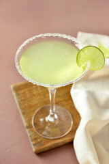 Glass with tasty daiquiri cocktail on color background