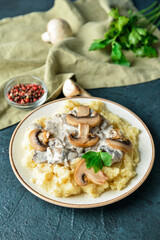 Plate with tasty mashed potatoes, mushrooms and peppercorns on color background