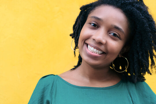 Close upside portrait of beautiful smiling young Black woman lea