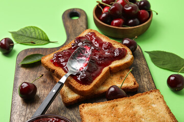 Toasts with tasty cherry jam on color background