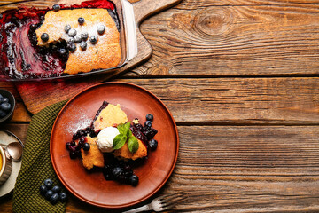 Composition with blueberry cobbler and ice cream on wooden background