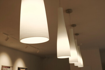 Included chandeliers on the ceiling close-up. Light and interior design. Office lamps 