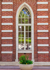 window on the wall in a gothic brick building
