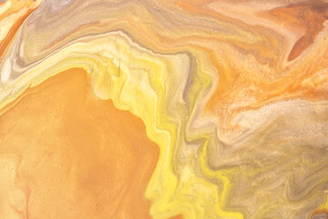 Abstract fluid art background light yellow and orange colors. Liquid marble. Acrylic painting with golden gradient