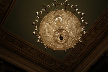 Luxury interior chandelier has light candles and dark background