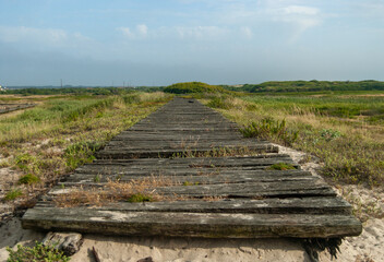 Old wooden pathway in the countryside with a beautiful misty sky - Costa Nova Beach, Aveiro, Portugal, 10.06.2021