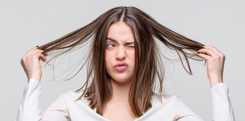 Fototapeta premium Girl having a bad hair. Bad hairs day. Frustrated woman having a bad hair. Woman having a bad hair, her hair is messy and tangled
