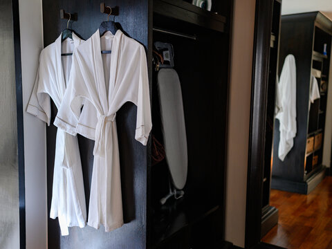 A bathrobe is hung on the wall in the dressing room to use for bathing.