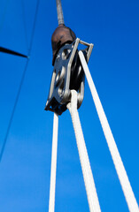 Block with ropes for fastening the mast and sail on a sailing yacht.