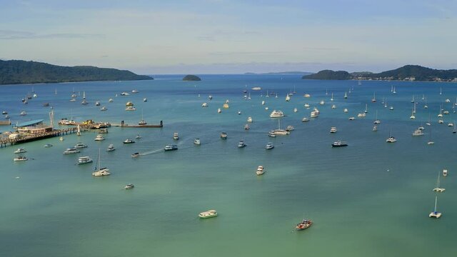 Aerial view of the marina lot. Docked sailboats and catamarans in yacht club. Lack of tourists due to lockdown of tropical countries. The consequences of coronavirus for the tourism business.