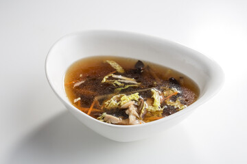 Miso soup with shiitake mushrooms isolated on white background