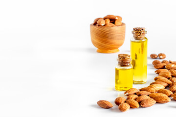 Almond oil in bottle with almond nuts. Extra virgin essence oil