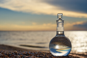 Glass flask by the sea.