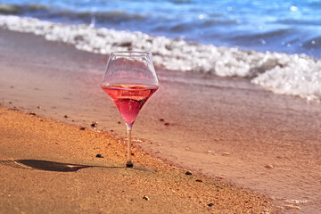 Wine glass with a cocktail by the sea.