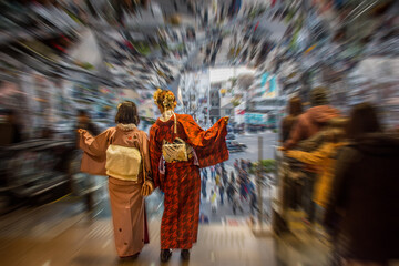 The unidentified Japanese girl in traditional and national dressing called "Kimono" is posing and action for photo shooting with motion zoom blurred background presented of time warp, fast motion zoom