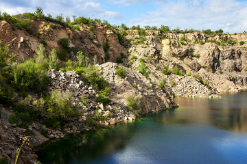 Panoramic view on old flooded granite quarry with radon lake near the Southern Bug river in Mygiya, Ukraine.