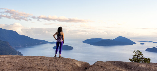 Adventurous Caucasian Adult Woman hiking on top of a mountain. Summer Sunset Sky Art Render. Tunnel...