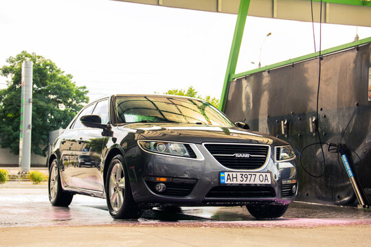 Chernigov, Ukraine - July 24, 2021: Saab car at a car wash. Gray Saab 9-5 car at a self-service car wash
