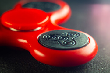Closeup shot of a red spinner on a black surface