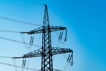 Silhouette of electric supply station. Dark shadow of high voltage line.