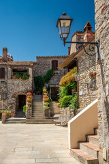 beautiful medieval houses with lantern in picturesque tuscan village of Capalbio