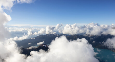 Aerial View from Airplane of Canadian Mountain Landscape. Sunny Summer Clouds. Garibaldi Park between Squamish and Whistler, North of Vancouver, BC, Canada.