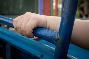 Child hand holding handlebar steel