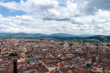 Red rooftops of Florence with the Santa Croce Basilica in the background.