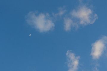 Fluffy clouds forming in the shape of cotton with blue sky in the background
