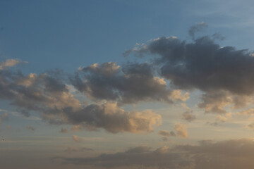 Fluffy clouds forming in the shape of cotton with blue sky in the background
