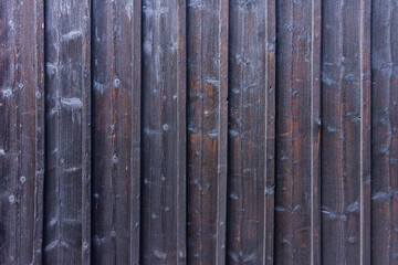 Structure of the old wooden paneling of the house of the first half of the 20th century treated with fire and thus protecting the structure from attack by fungi and molds