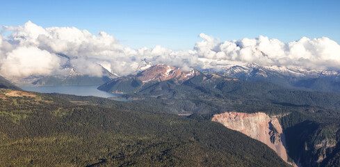 Naklejka premium Aerial View from Airplane of Canadian Mountain Landscape. Sunny Summer Cloudy evening. Garibaldi between Squamish and Whistler, North of Vancouver, BC, Canada.