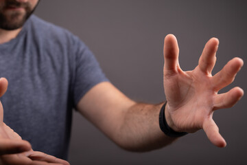male  shows outstretched hand with open palm