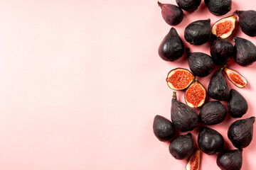 Fresh whole and sliced fig isolated on pastel pink background, top view. Ripe sweet figs . Healthy mediterranean fig fruit.